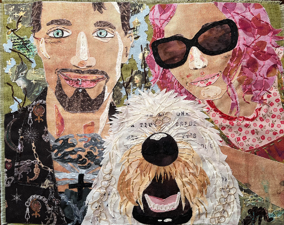 A textile art piece depicting a man and a woman posing with a fluffy white dog. The man has tattoos and is wearing a dark outfit, while the woman has pink hair and sunglasses. The background features various colorful patterns and elements.